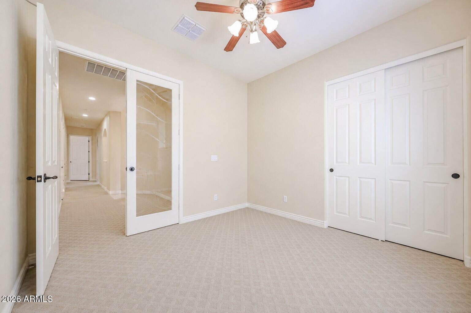 18175 West Narramore Road Goodyear, AZ 85338 - Photo 21 of 72 a view of an empty room with a chandelier fan
