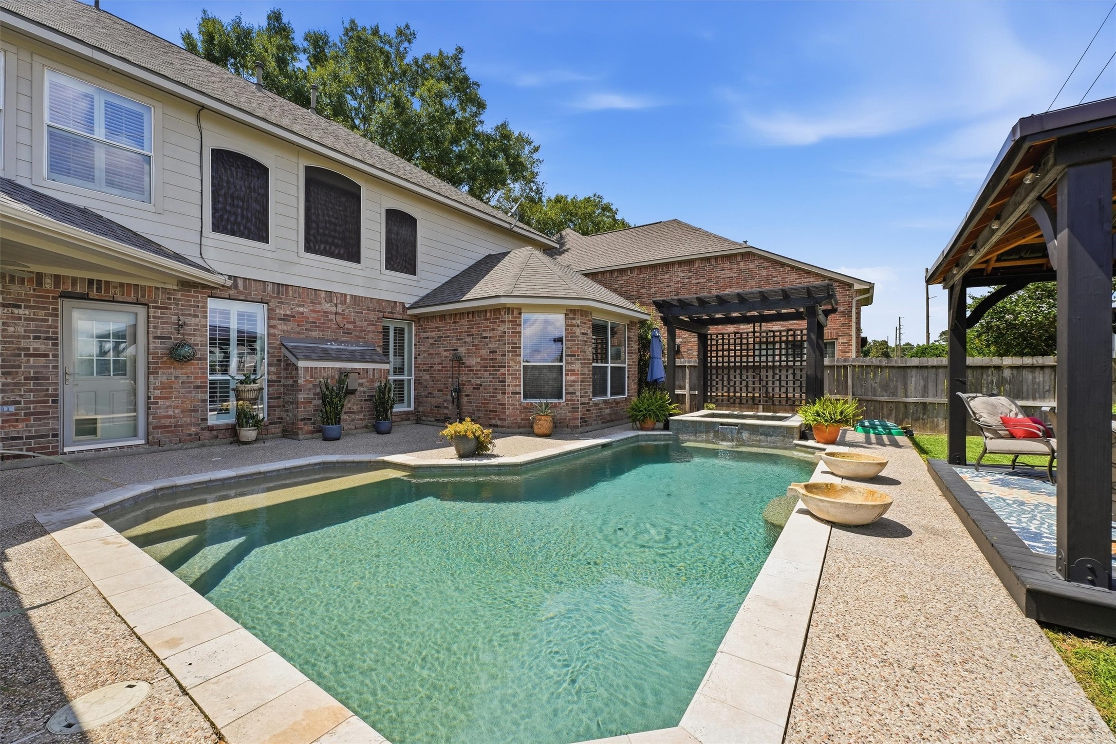25181 Ramrock Drive Porter, TX 77365 - Photo 25 of 35 a view of a house with backyard sitting area and swimming pool