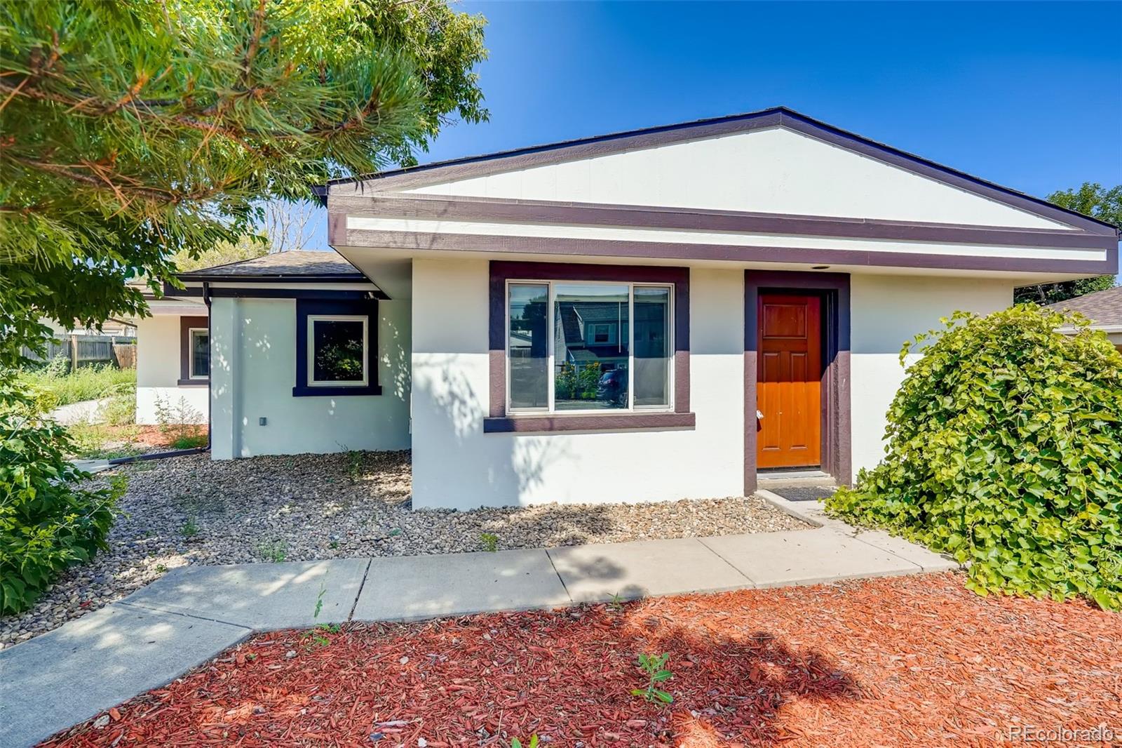 5535 Tejon Street Denver, CO 80221 - Photo 1 of 23 a front view of a house with a yard and garage