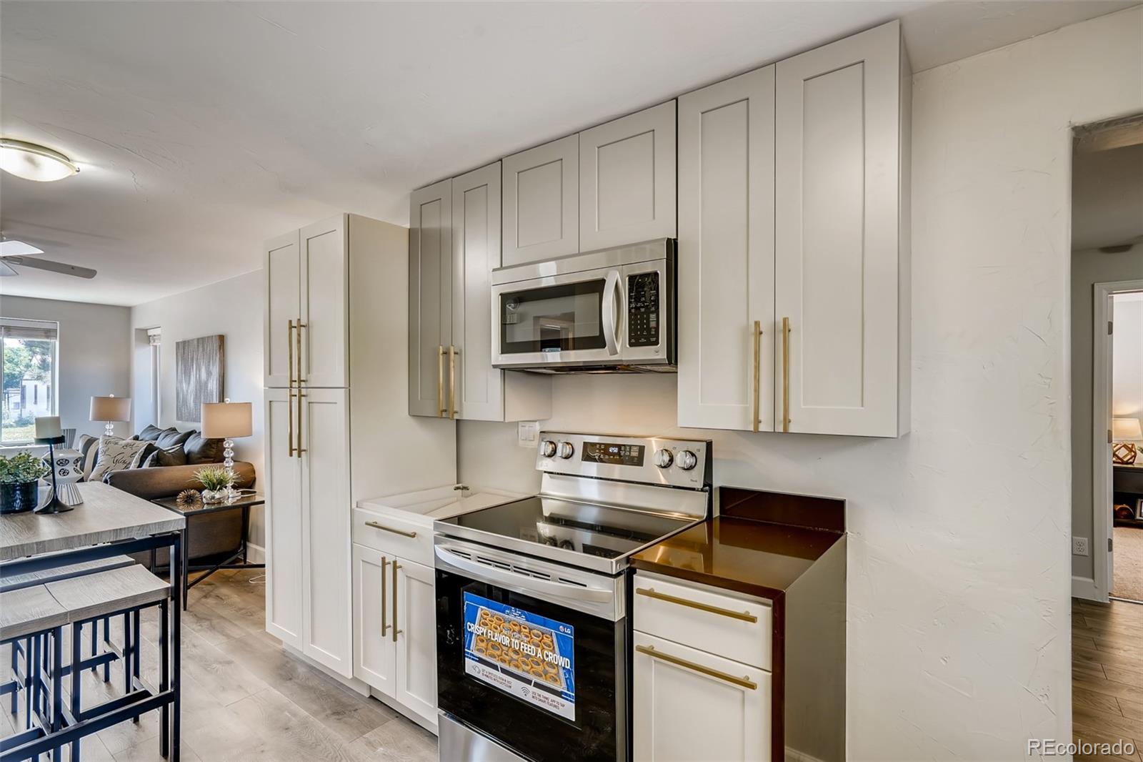 5535 Tejon Street Denver, CO 80221 - Photo 11 of 23 a kitchen with a stove and a microwave