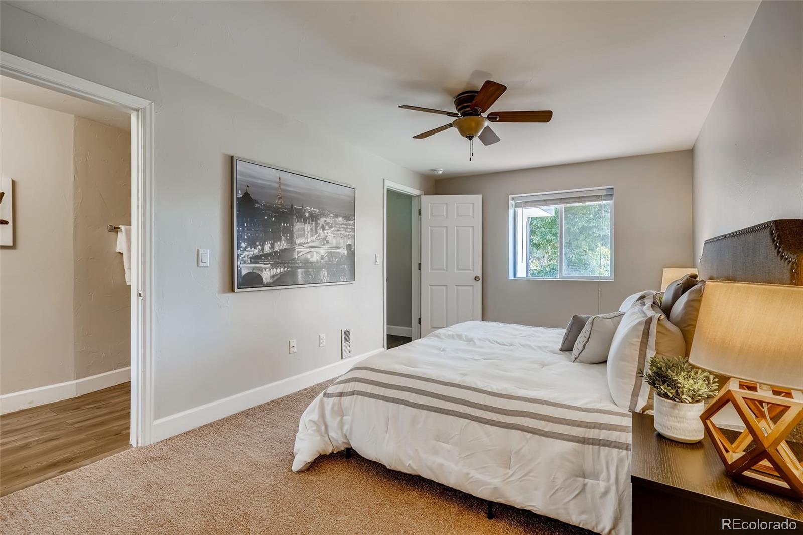 5535 Tejon Street Denver, CO 80221 - Photo 13 of 23 a bedroom with a large bed and a window