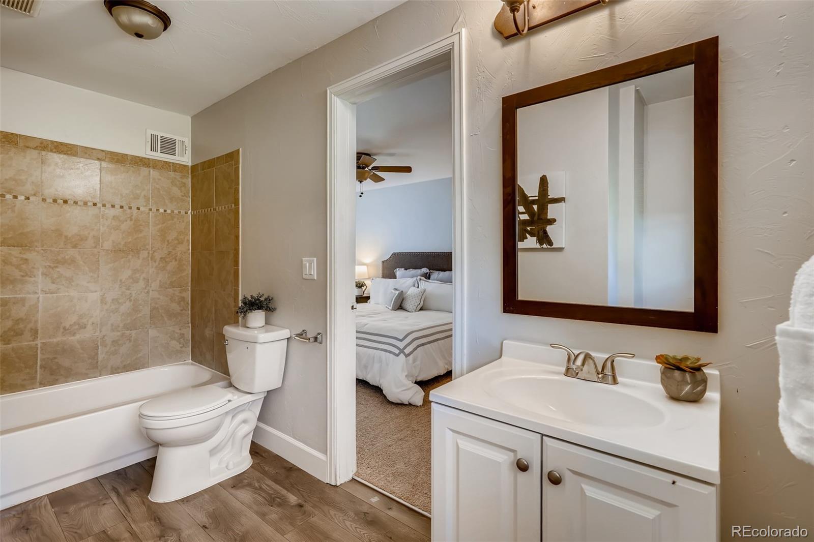 5535 Tejon Street Denver, CO 80221 - Photo 14 of 23 a bathroom with a toilet sink and mirror