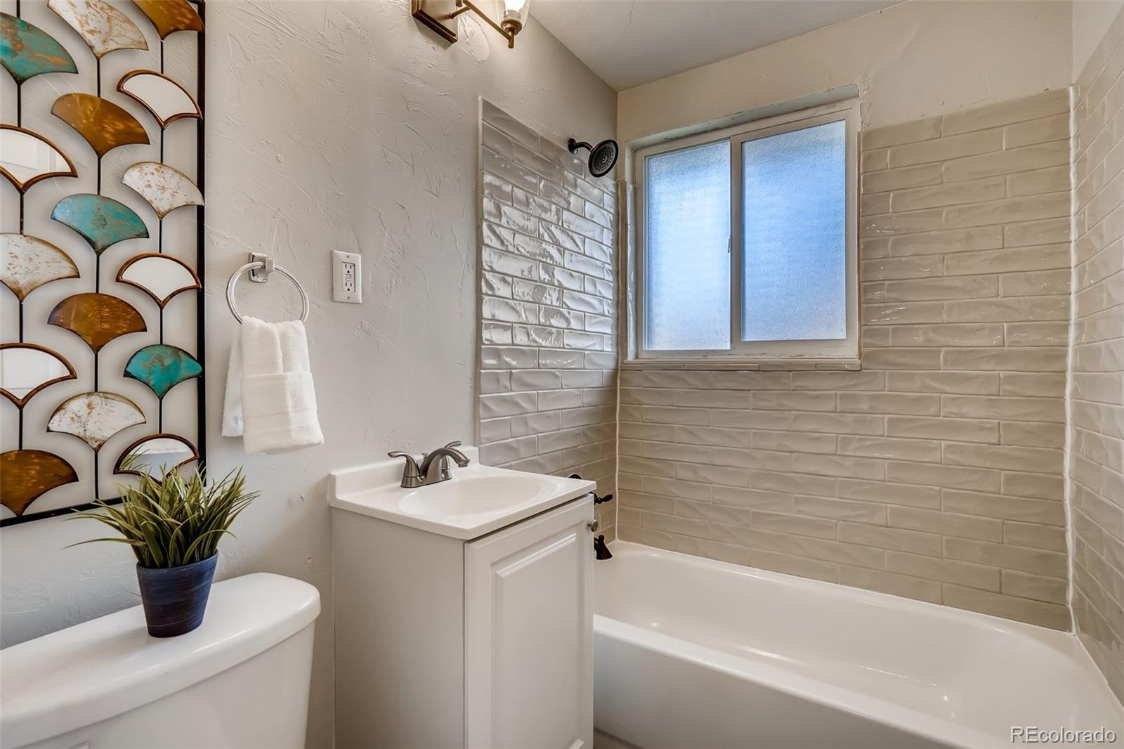 5535 Tejon Street Denver, CO 80221 - Photo 17 of 23 a bathroom with a sink a toilet and a bathtub