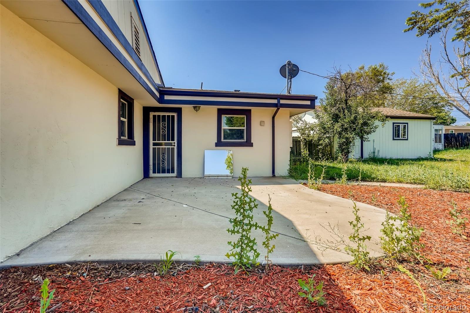 5535 Tejon Street Denver, CO 80221 - Photo 19 of 23 a front view of a house with a yard and garage
