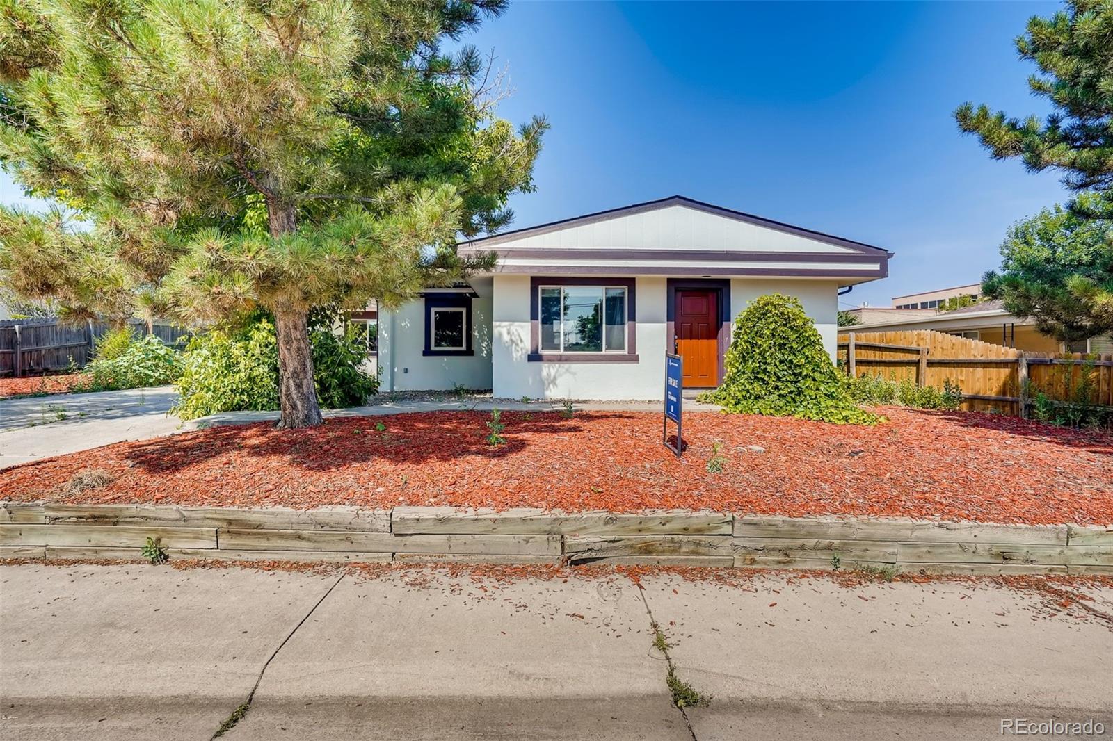 5535 Tejon Street Denver, CO 80221 - Photo 2 of 23 a front view of a house with garden