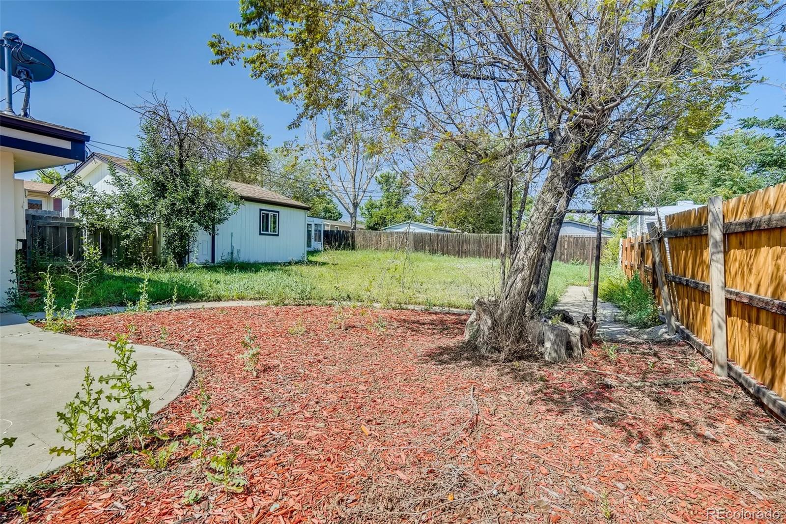 5535 Tejon Street Denver, CO 80221 - Photo 21 of 23 a backyard of a house with outdoor seating