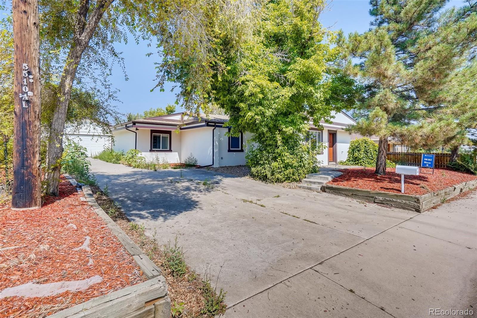 5535 Tejon Street Denver, CO 80221 - Photo 3 of 23 a front view of a house with garden