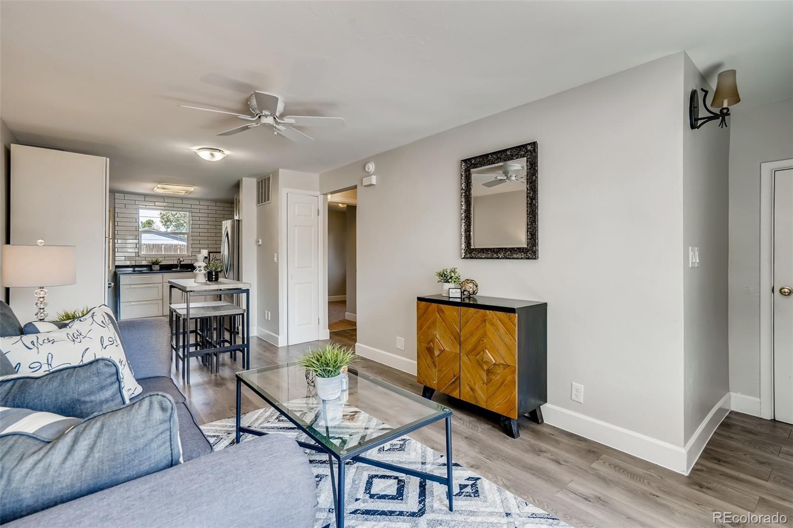 5535 Tejon Street Denver, CO 80221 - Photo 5 of 23 a living room with furniture and a flat screen tv