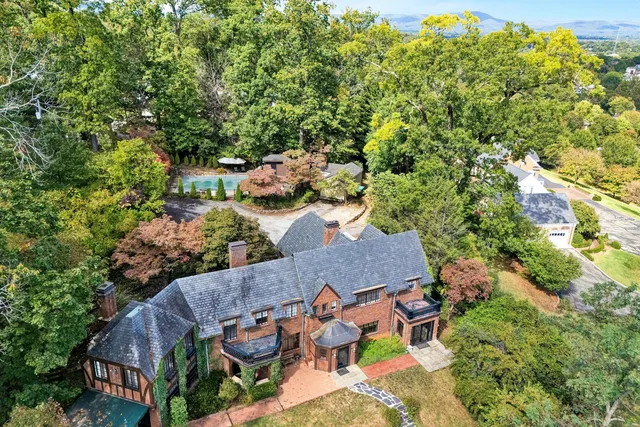 an aerial view of a house with yard swimming pool and outdoor seating