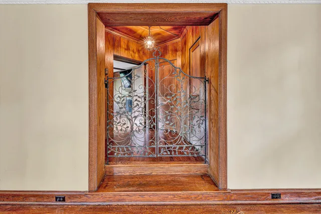 a dining room with furniture a chandelier and glass door