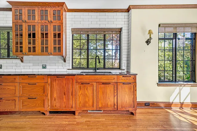 a view of a kitchen with wooden floor and a ceiling fan