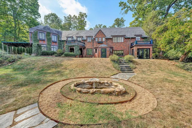 a view of an empty room with window and fire place