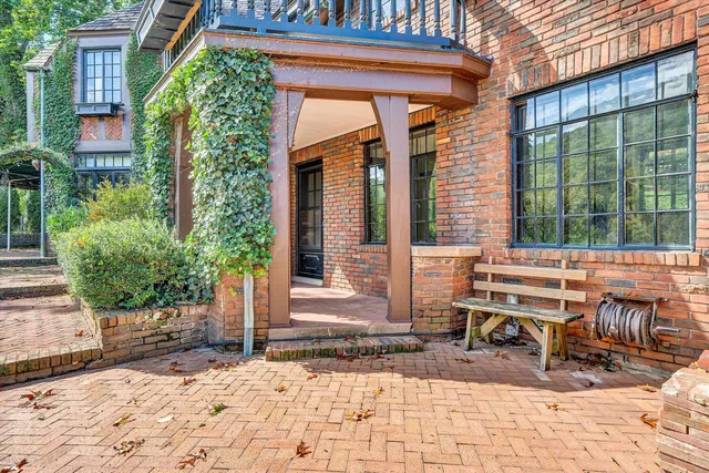 a view of an empty room with a fireplace and a window