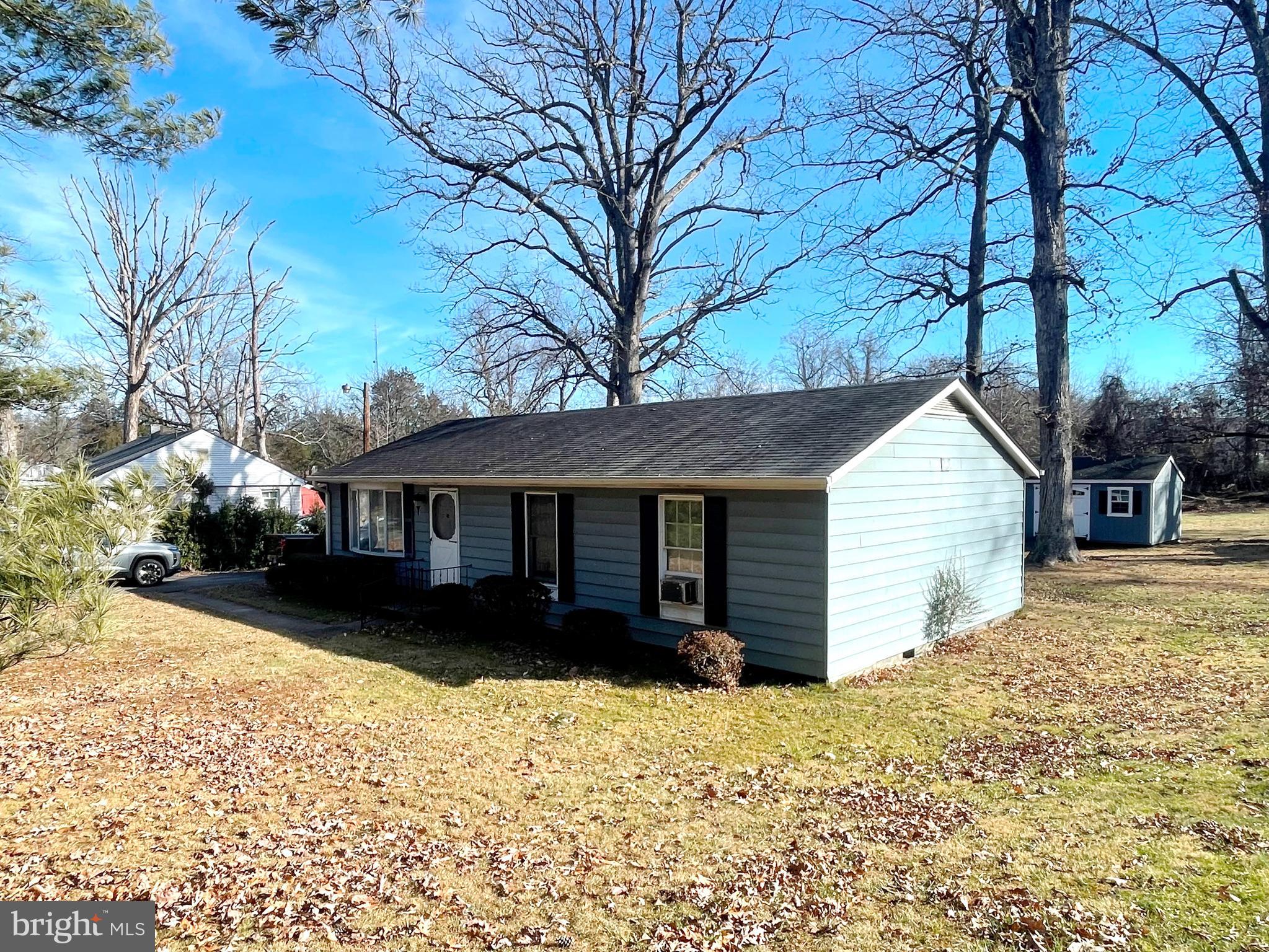 a view of a house with a yard covered in snow