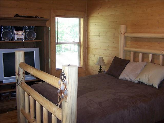 389 North Scenic Road Monteagle, TN 37356 - Photo 7 of 12 Guest bedroom on upper level - the smell and look of wood surrounds you!