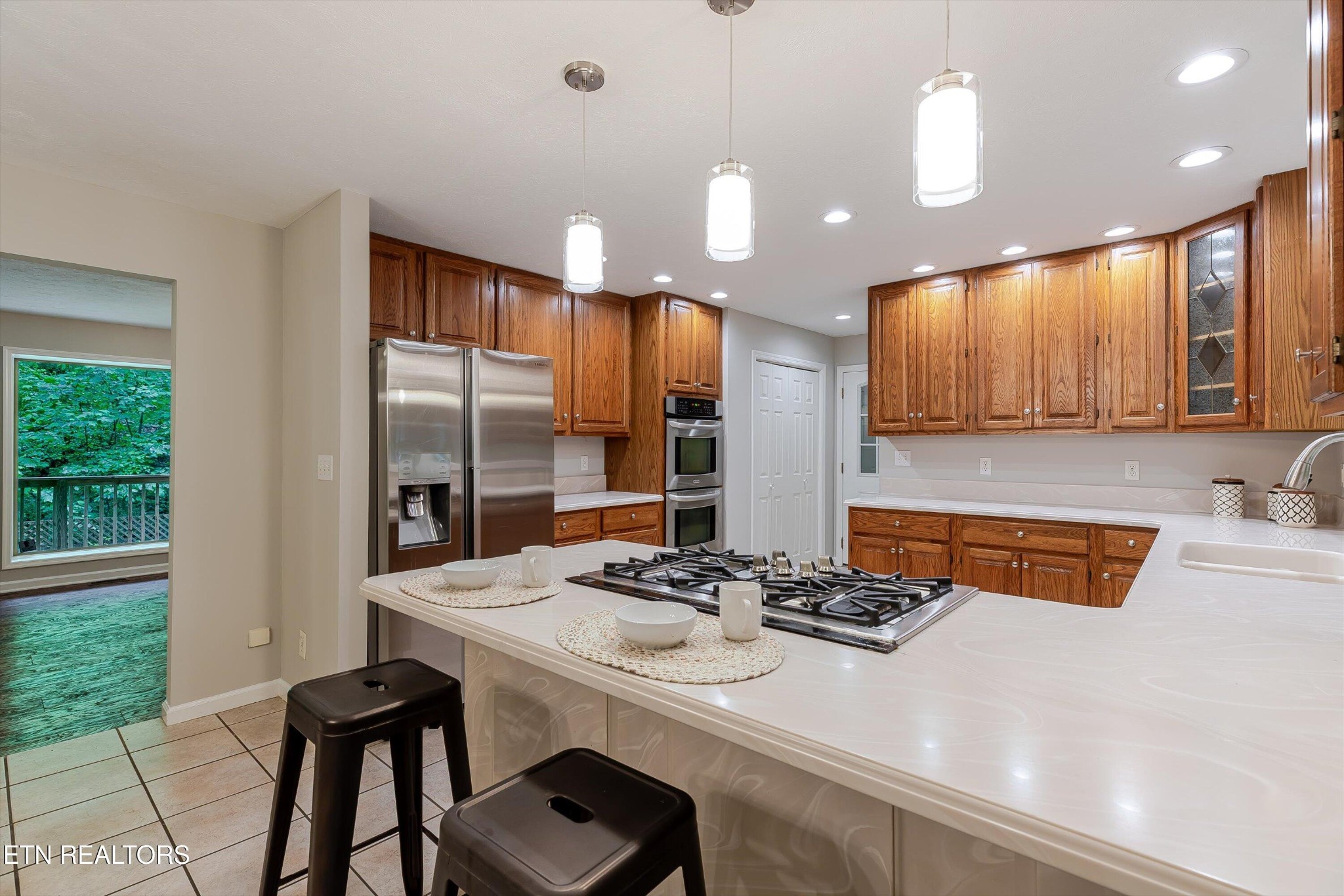 147 California Avenue Oak Ridge, TN 37830 - Photo 18 of 39 a kitchen with stainless steel appliances kitchen island granite countertop a sink and cabinets
