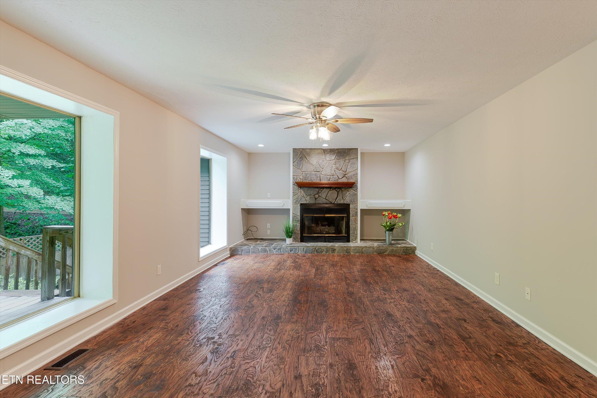 147 California Avenue Oak Ridge, TN 37830 - Photo 10 of 39 a view of an empty room with wooden floor fireplace and a window