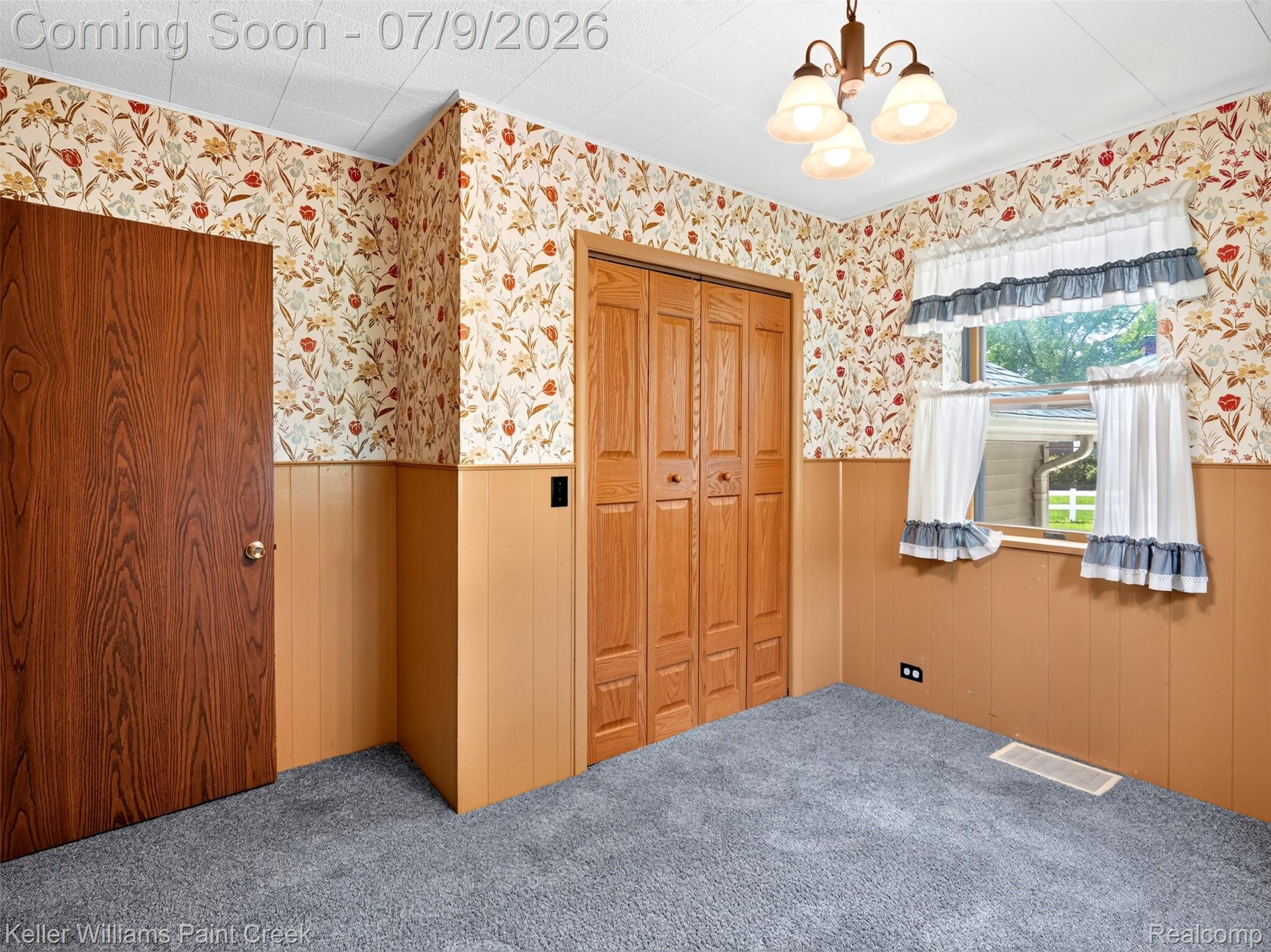 204 Russell Road Kawkawlin, MI 48631 - Photo 36 of 82 Interior room featuring gray carpeting, wood-paneled wainscoting, and floral wallpaper