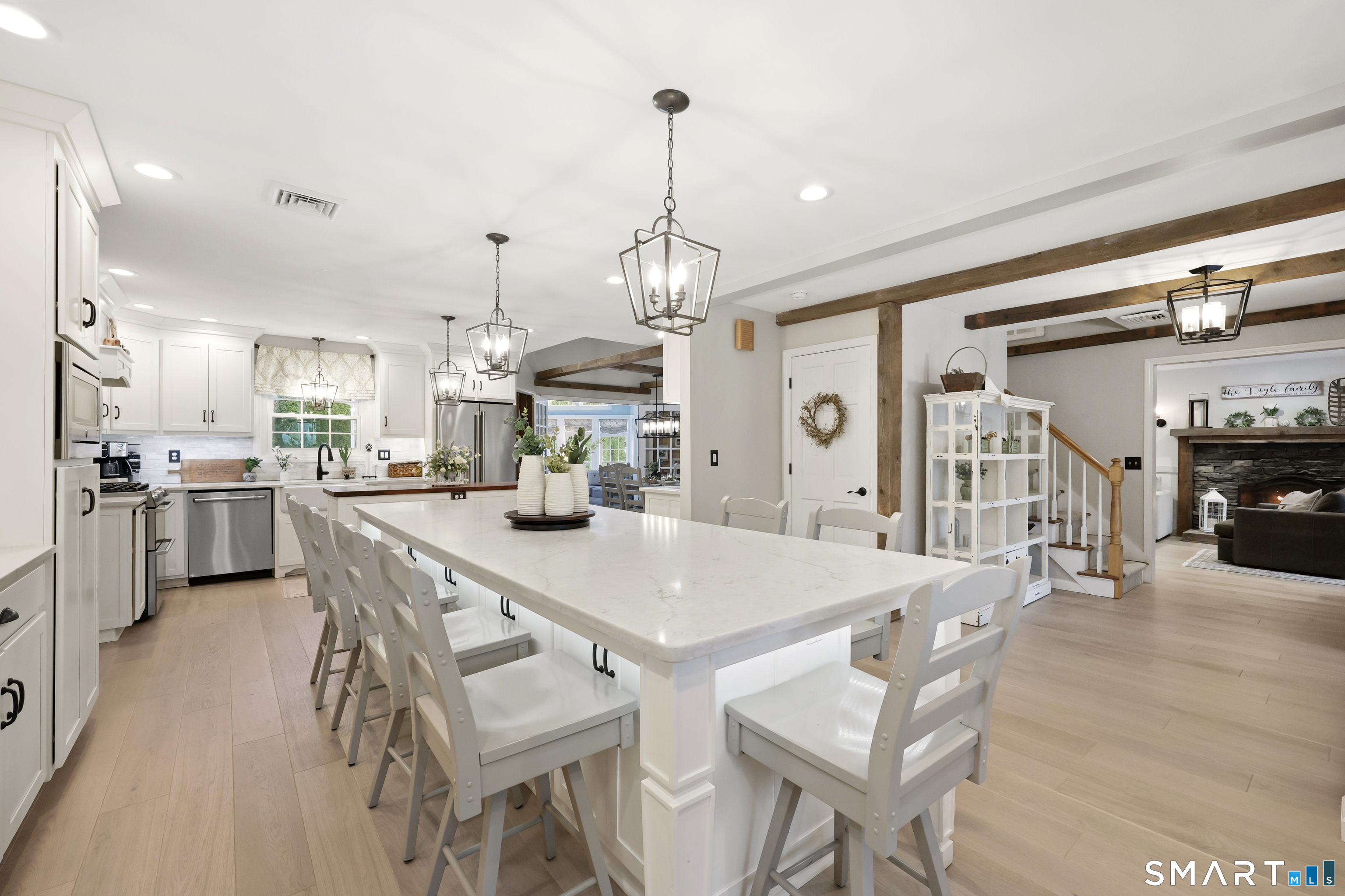 35 Quail Run Harwinton, CT 06791 - Photo 5 of 40 a view of a dining room and livingroom with furniture wooden floor a chandelier