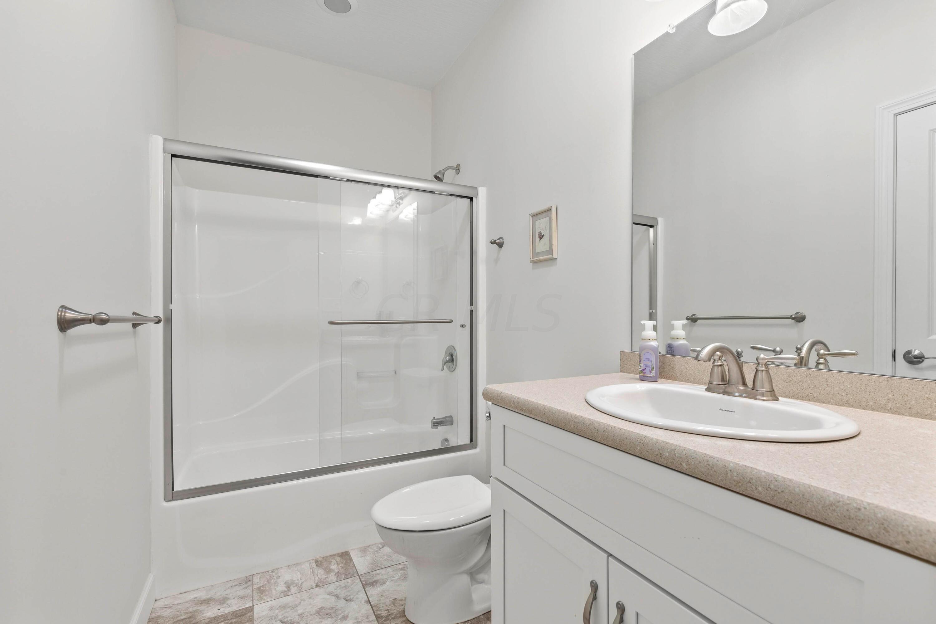 3644 Panhandle Road Delaware, OH 43015 - Photo 7 of 46 • “Ceramic look” vinyl flooring
• Ivory painted walls
• Enclosed vanity with single
bowl sinktop
• Tub/shower combination with
glass doors
• Lighted ceiling exhaust
• Linen closet