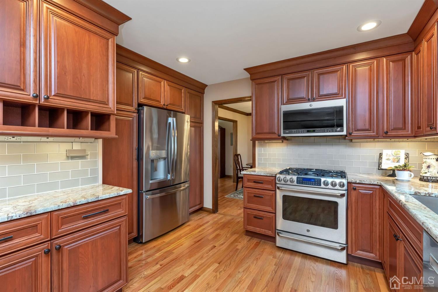 28 Harkins Road Milltown, NJ 08850 - Photo 16 of 46 a kitchen with stainless steel appliances granite countertop a stove a refrigerator and a microwave