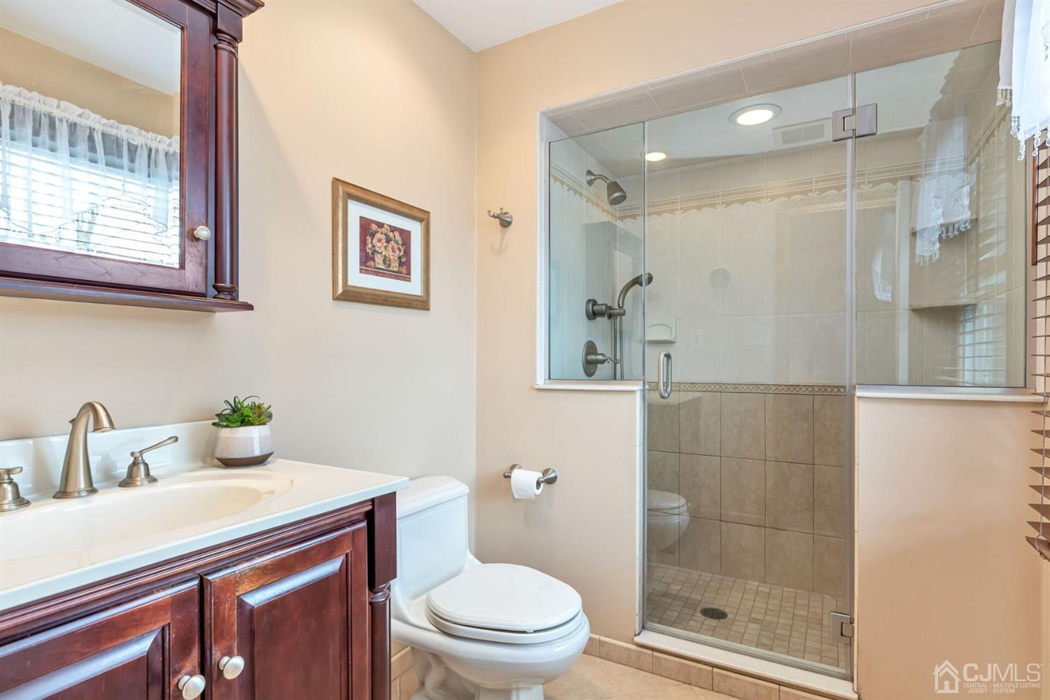 28 Harkins Road Milltown, NJ 08850 - Photo 32 of 46 a bathroom with a sink a toilet and shower