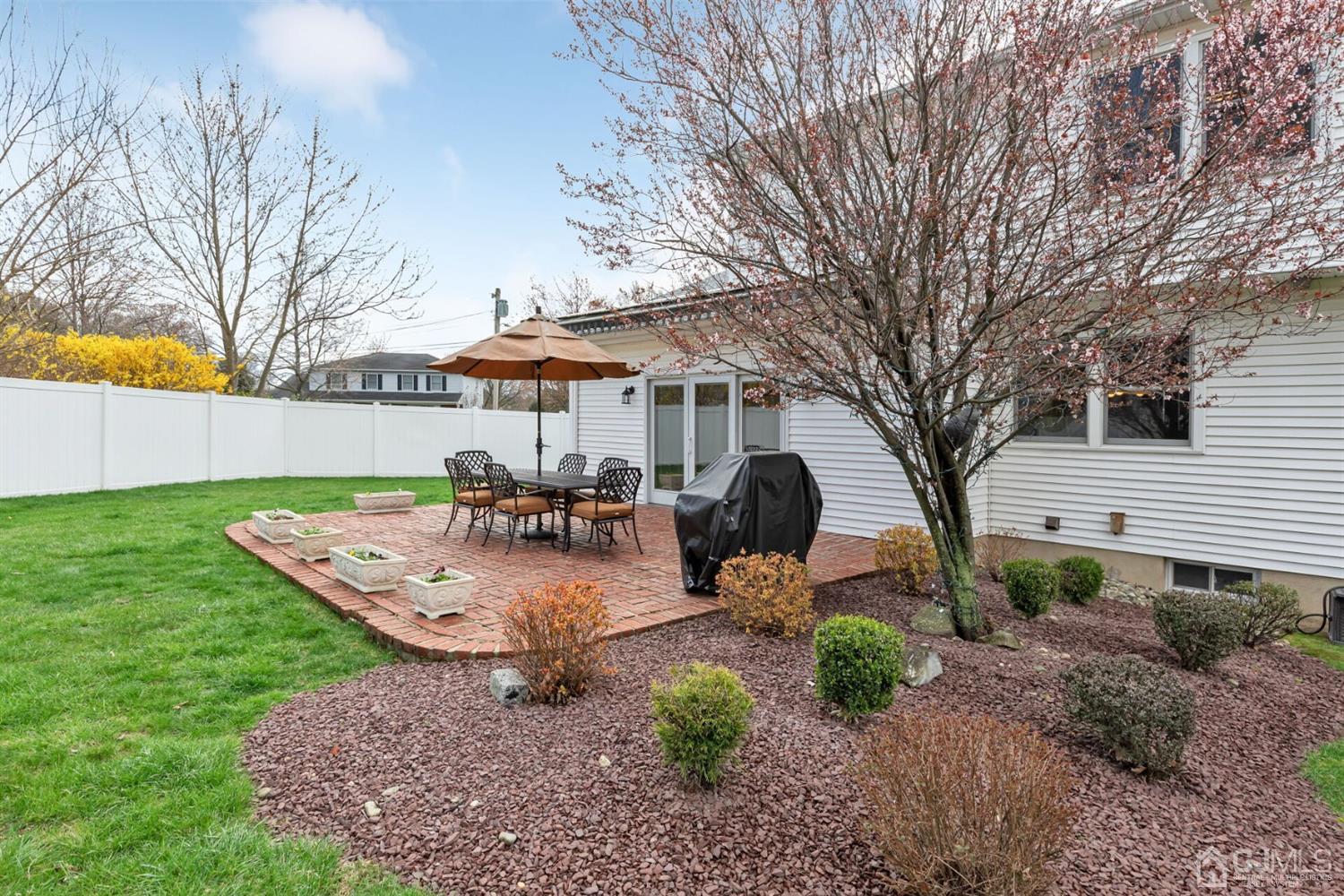 28 Harkins Road Milltown, NJ 08850 - Photo 40 of 46 a view of a backyard with table and chairs under an umbrella