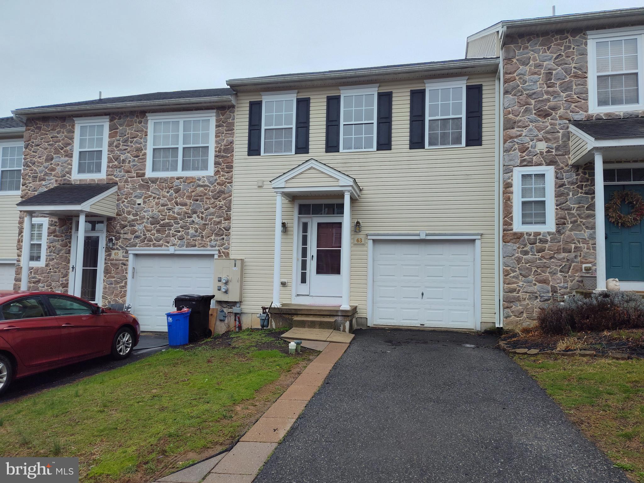 63 Sugar Maple Road Barto, PA 19504 - Photo 1 of 3 a front view of a house with a garden and trees