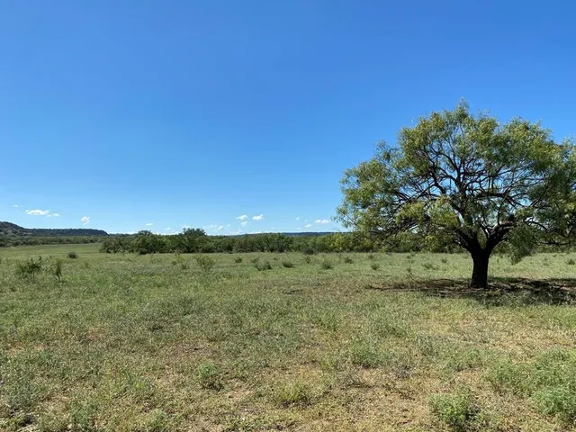 a view of a building in the middle of a field