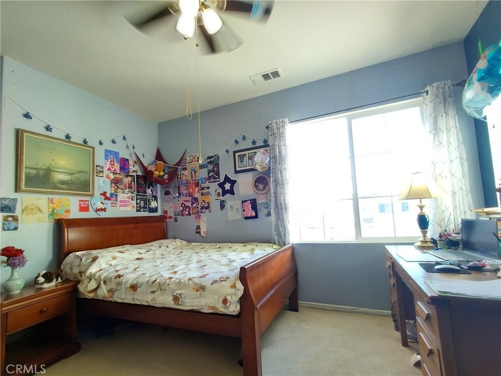 11811 Cramer Road Yucaipa, CA 92399 - Photo 37 of 56 a bedroom with a bed and a flat screen tv