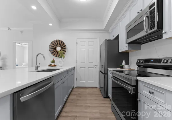 a kitchen with a sink stove and cabinets