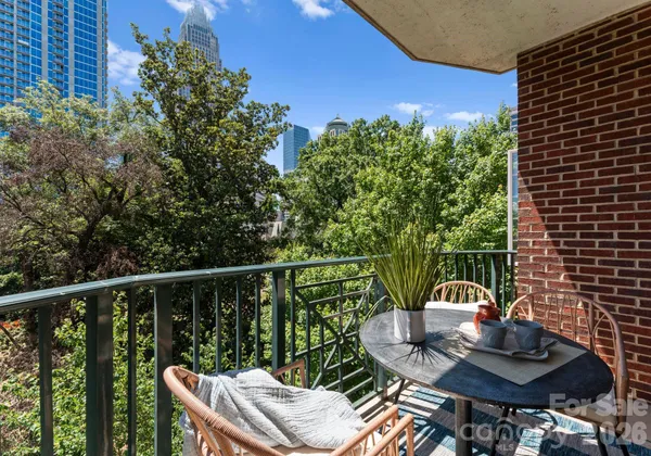 a balcony with table and chairs