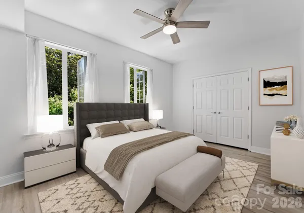 a bedroom with a large bed couch and a window