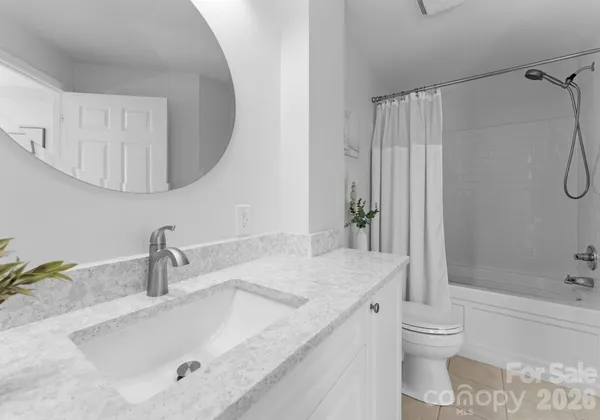 a bathroom with a granite countertop sink a toilet and shower