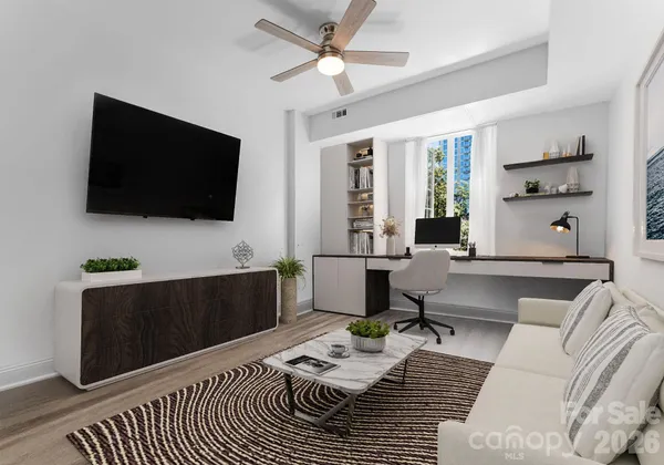 a living room with furniture and a flat screen tv