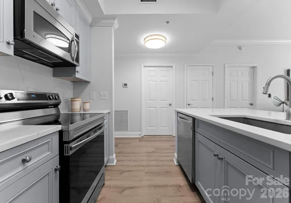 a kitchen with a sink stove and cabinets