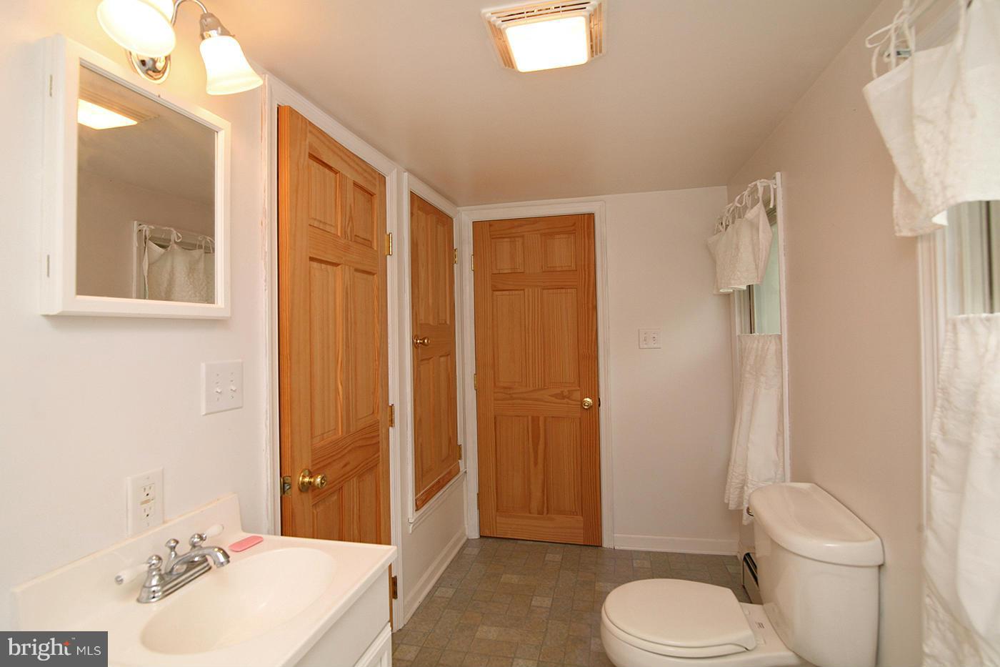 9050 New Cut Road Rocky Ridge, MD 21778 - Photo 12 of 24 a bathroom with a sink toilet and shower