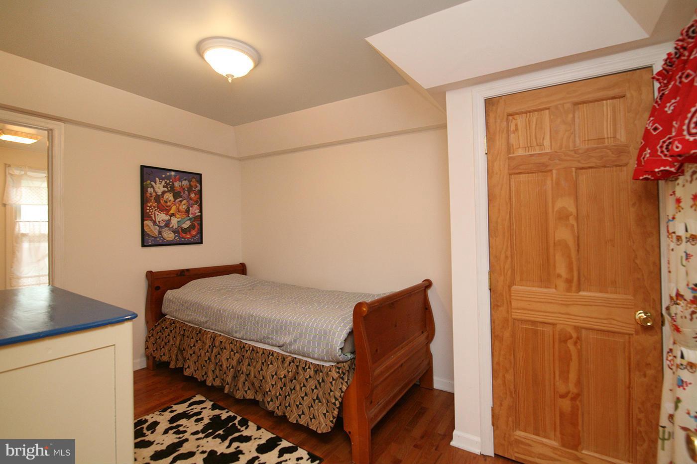 9050 New Cut Road Rocky Ridge, MD 21778 - Photo 13 of 24 a bedroom with a bed and wooden floor