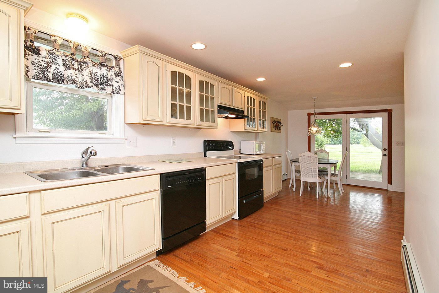 9050 New Cut Road Rocky Ridge, MD 21778 - Photo 3 of 24 a kitchen with granite countertop a sink stove top oven and cabinets