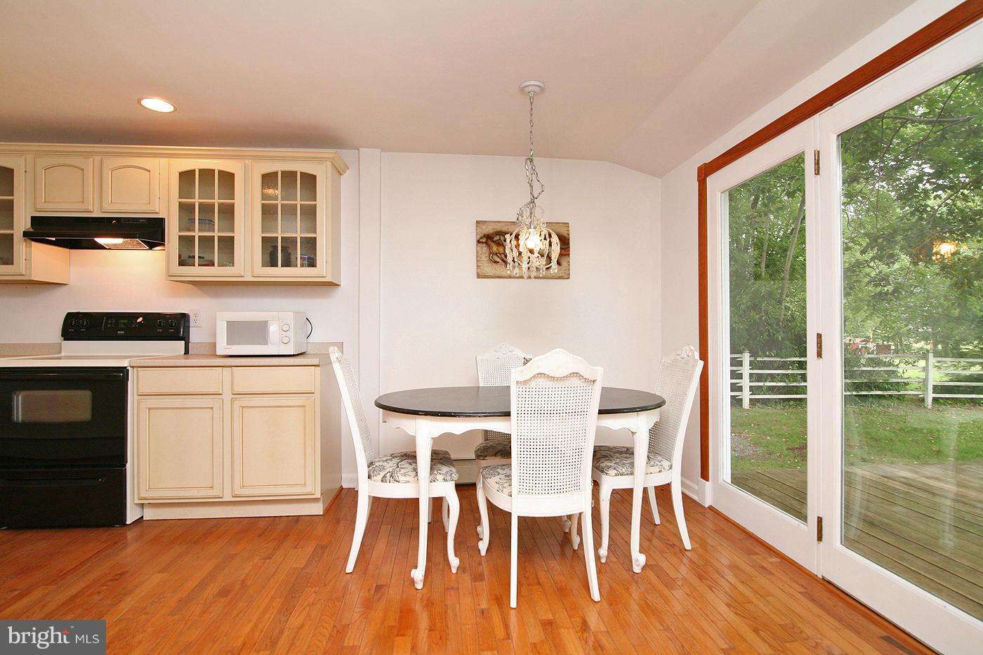 9050 New Cut Road Rocky Ridge, MD 21778 - Photo 5 of 24 a view of a dining room with furniture a chandelier and wooden floor