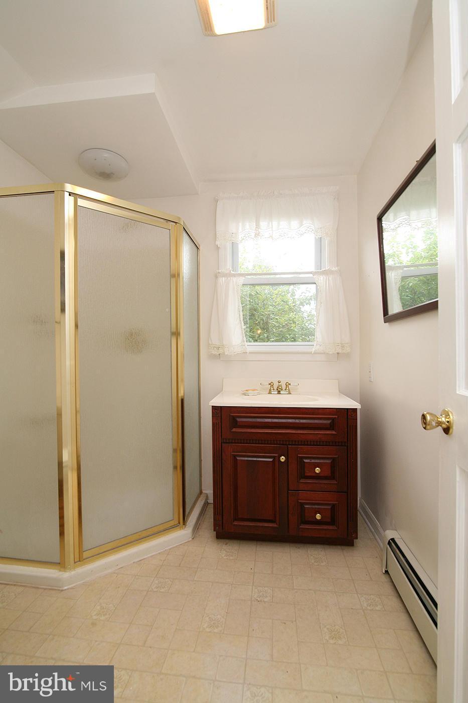9050 New Cut Road Rocky Ridge, MD 21778 - Photo 8 of 24 a room with a dresser and a mirror