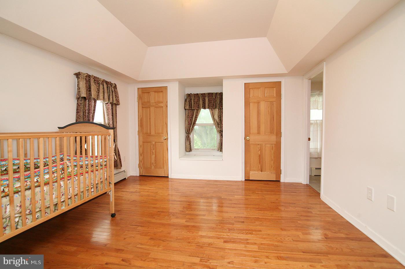 9050 New Cut Road Rocky Ridge, MD 21778 - Photo 9 of 24 a view of an empty room with wooden floor and a window