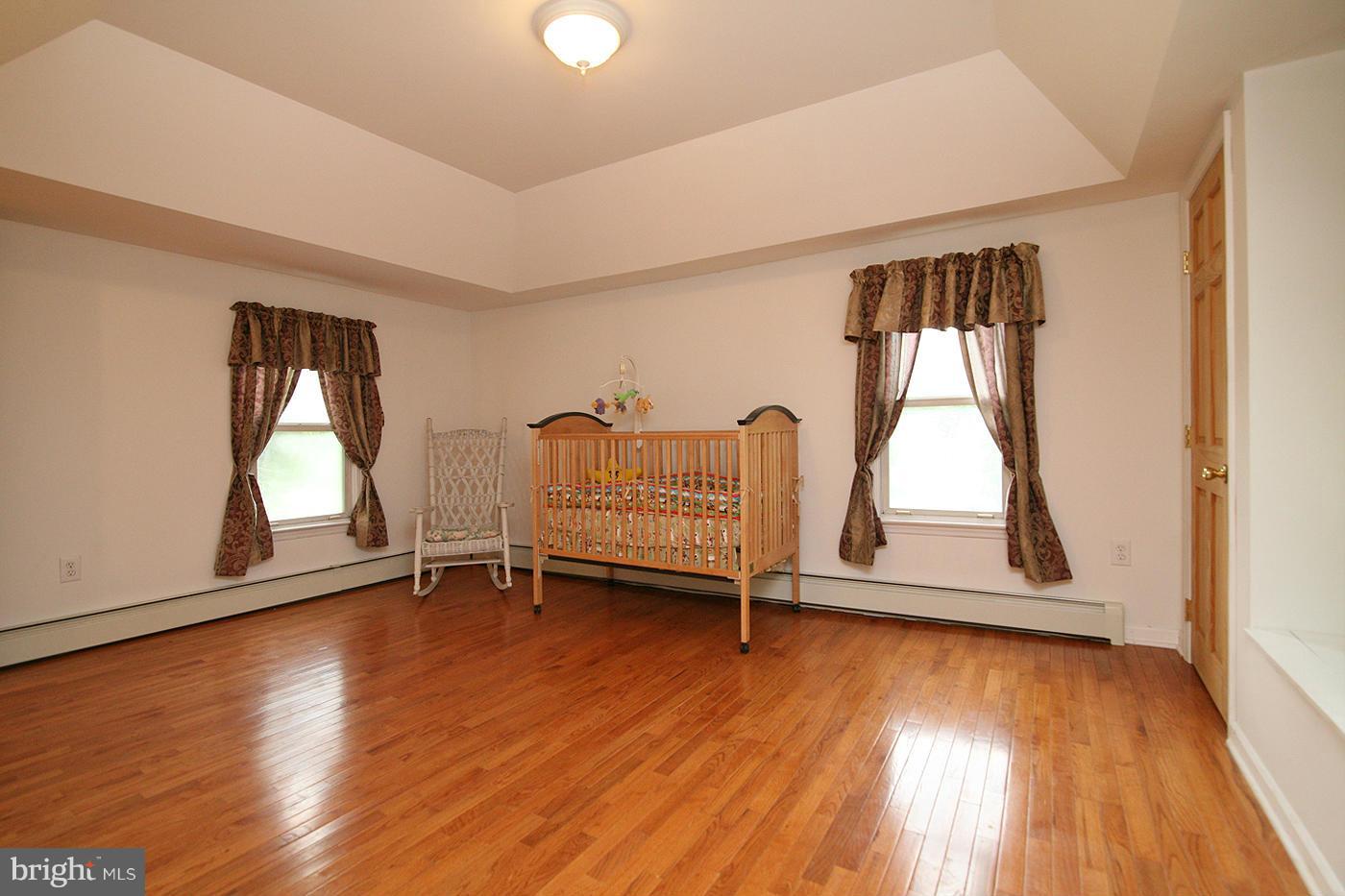 9050 New Cut Road Rocky Ridge, MD 21778 - Photo 10 of 24 an empty room with wooden floor and windows