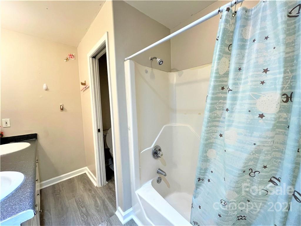 7002 Ware Road Charlotte, NC 28212 - Photo 14 of 21 a bathroom with a bathtub and a shower