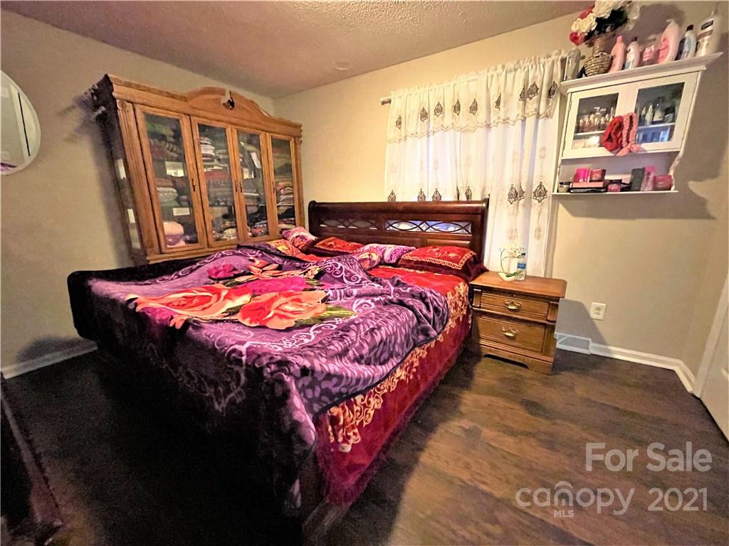 7002 Ware Road Charlotte, NC 28212 - Photo 16 of 21 a bedroom with a bed and a table in it