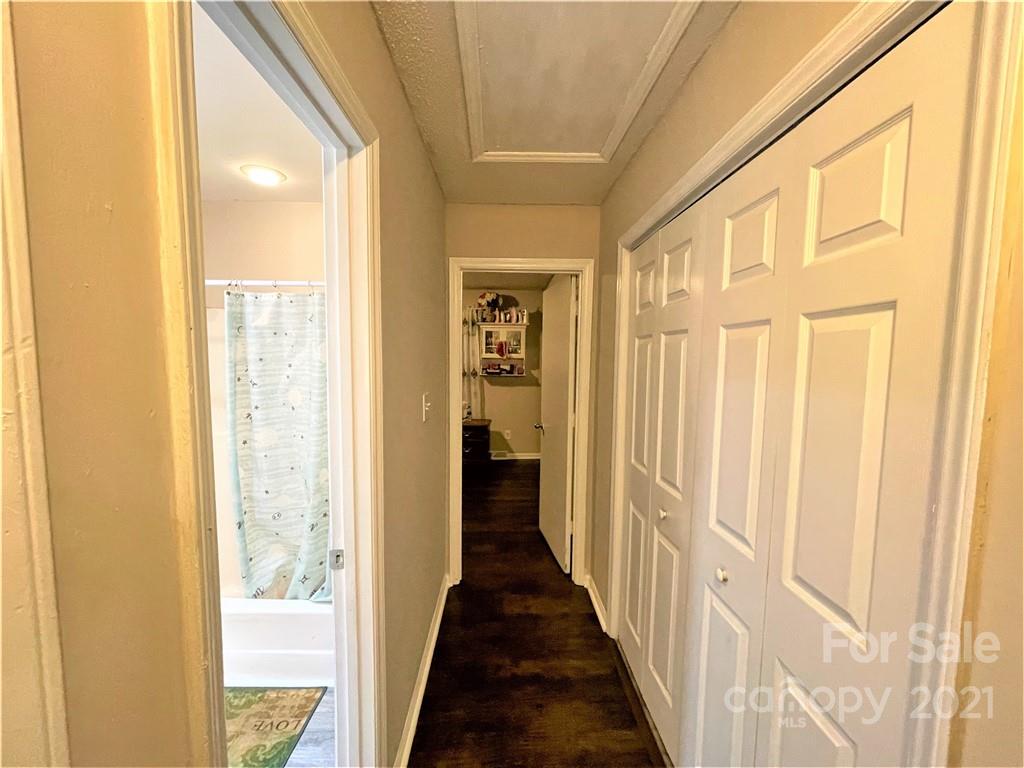 7002 Ware Road Charlotte, NC 28212 - Photo 18 of 21 a view of a hallway with wooden shelves