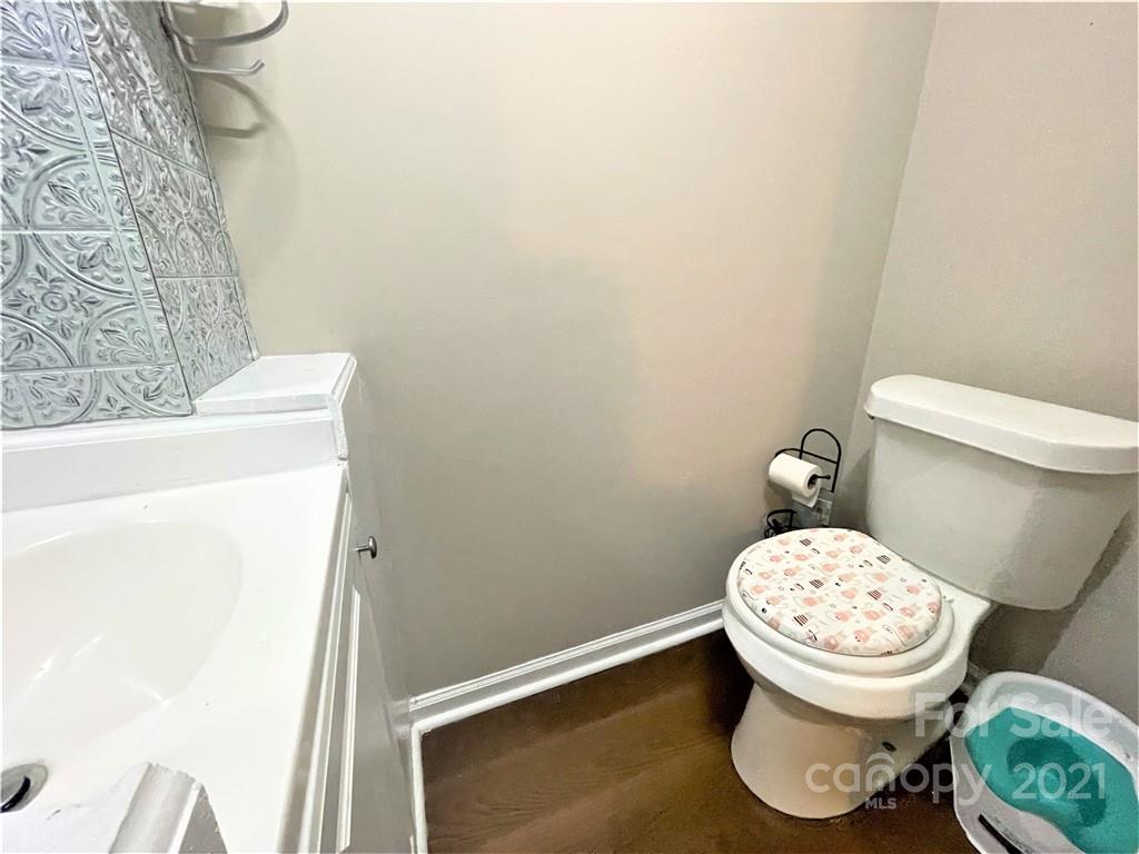 7002 Ware Road Charlotte, NC 28212 - Photo 21 of 21 a white toilet sitting next to a small sink