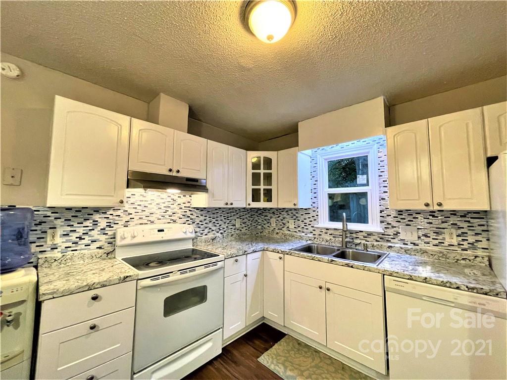 7002 Ware Road Charlotte, NC 28212 - Photo 6 of 21 a kitchen with granite countertop a sink a stove and cabinets
