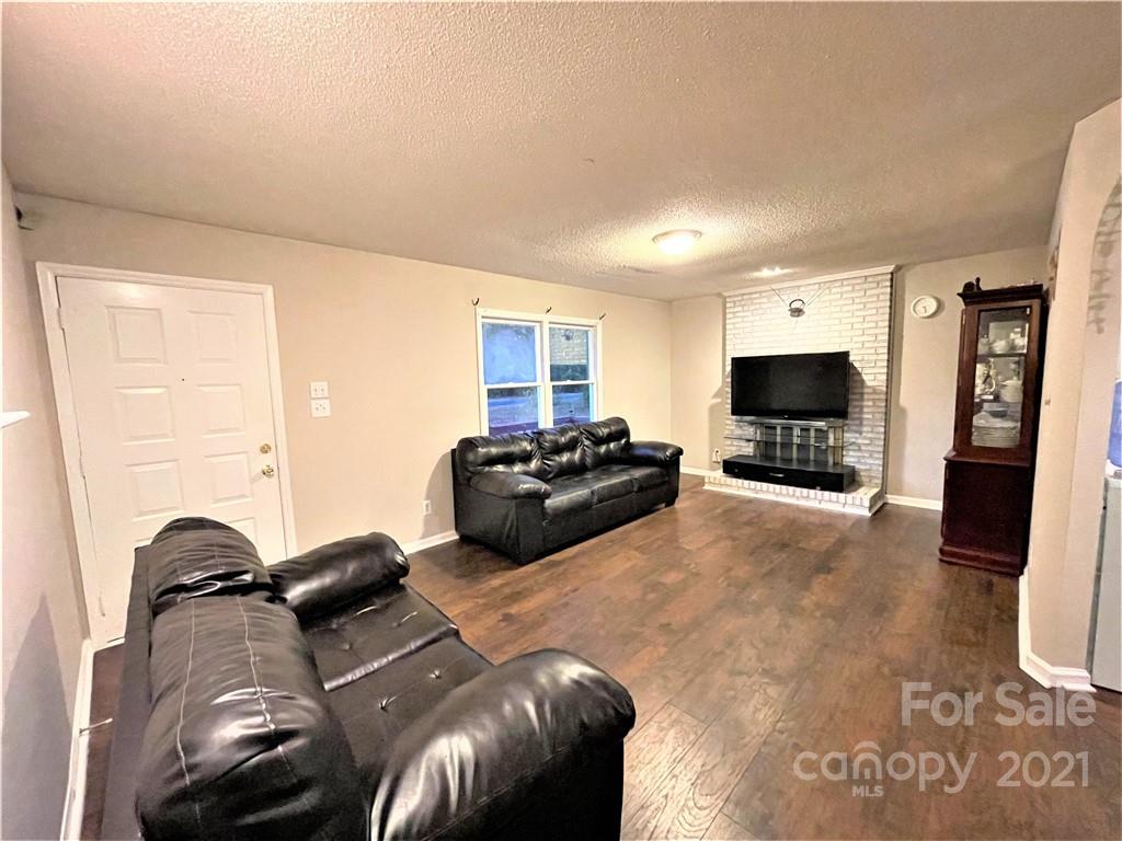 7002 Ware Road Charlotte, NC 28212 - Photo 9 of 21 a living room with furniture and a flat screen tv