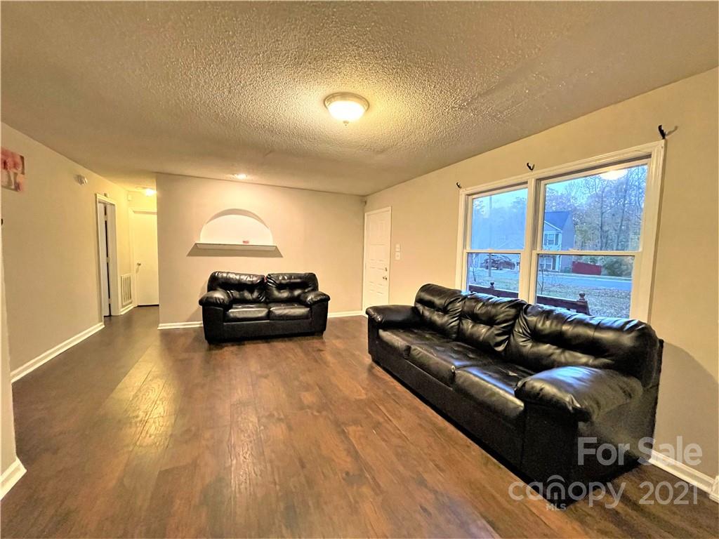 7002 Ware Road Charlotte, NC 28212 - Photo 10 of 21 a living room with furniture and a large window